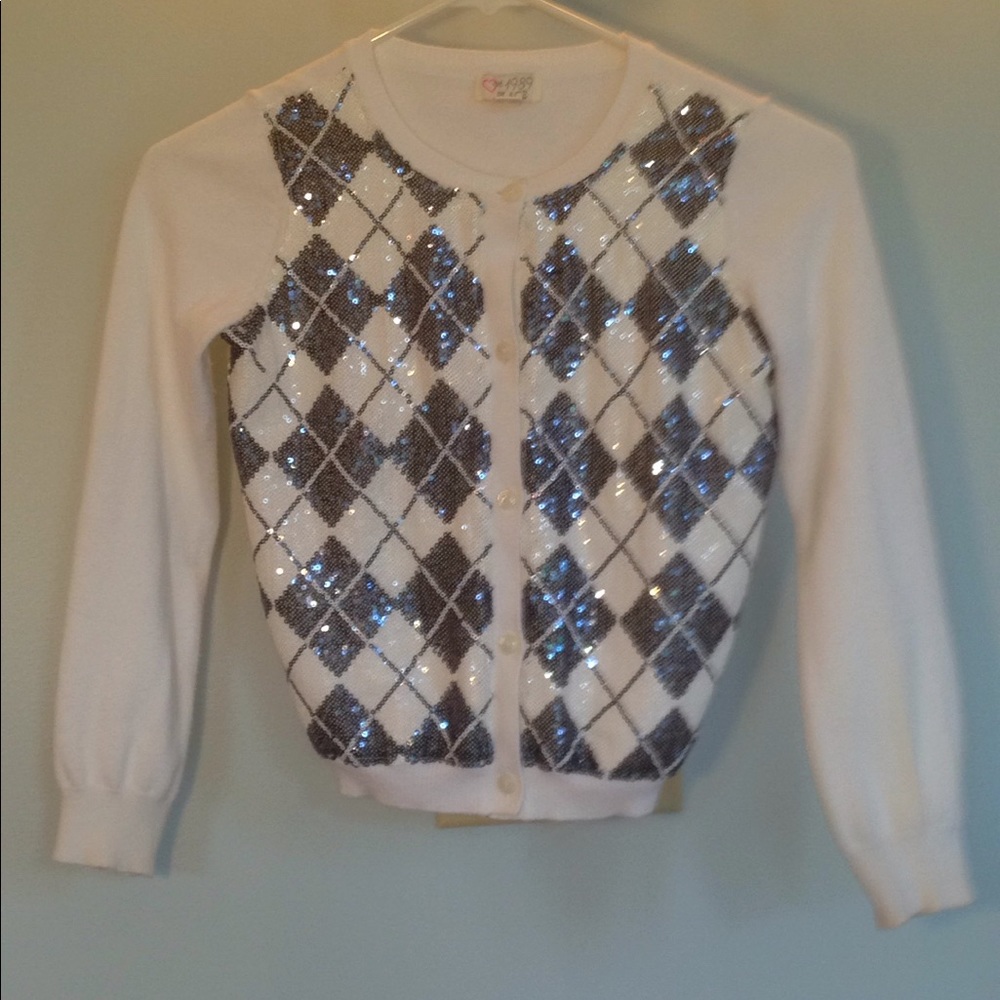 Size 7 sweater with buttons and glitter on it.